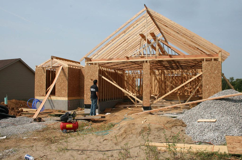 Roof trusses being set on a new house frame