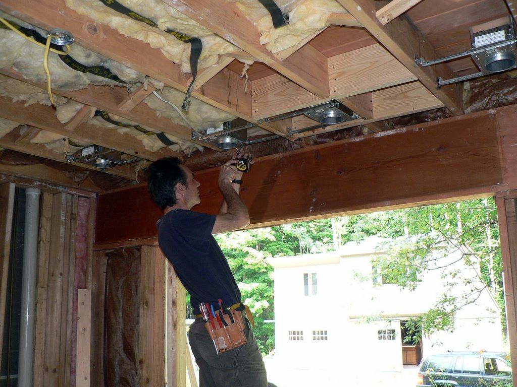 Carpenter installing a new beam during a main-floor renovation